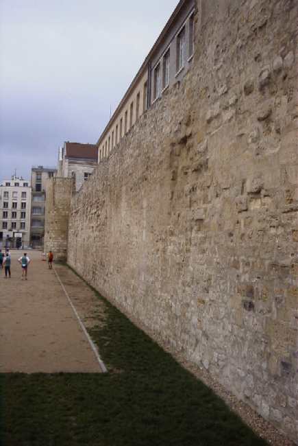 Firemen playing soccer against the city wall